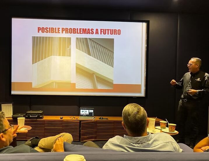 Presentation slide titled POSSIBLE FUTURE PROBLEMS with two images of building parts, audience in foreground. Presentation slide titled POSSIBLE FUTURE PROBLEMS with two images of building parts, audience in foreground.